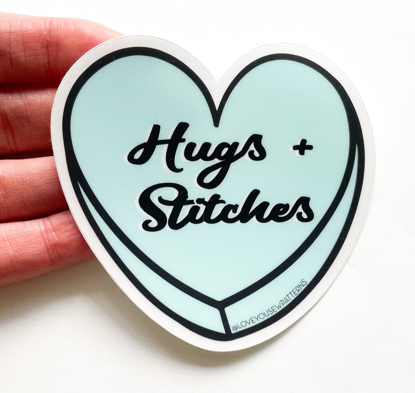 “Hugs + Stitches” Sticker