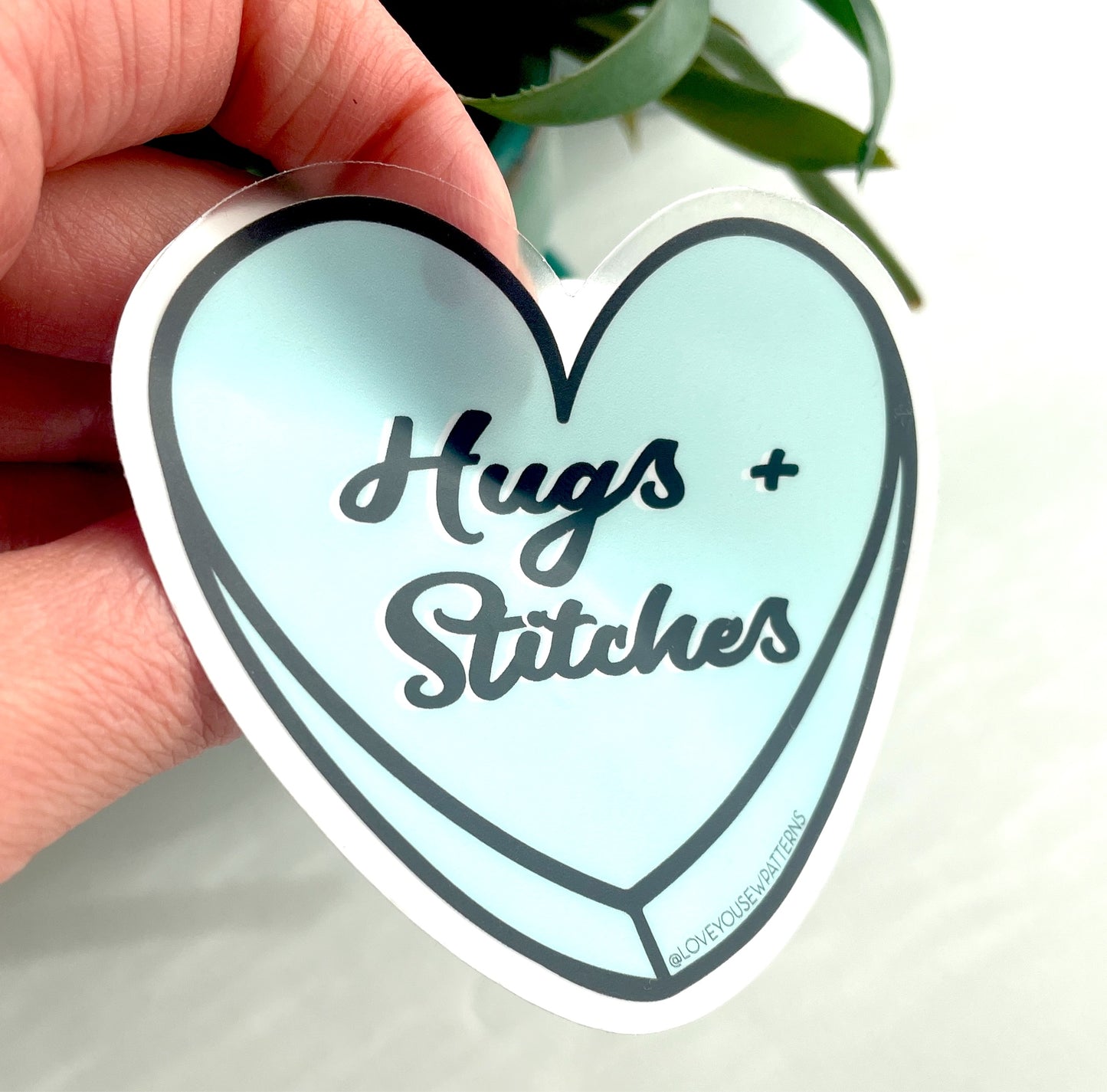 “Hugs + Stitches” Sticker